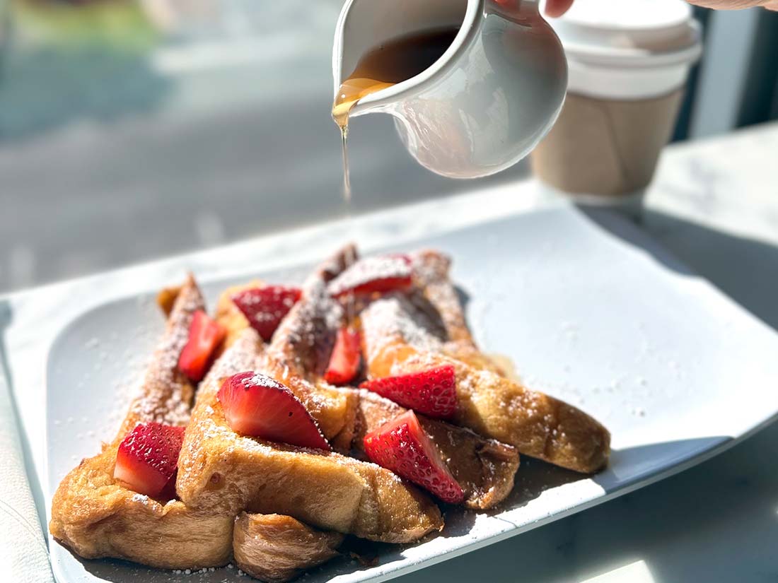 French toast at Sundrift Inn, topped with strawberries, powdered sugar, and maple syrup.