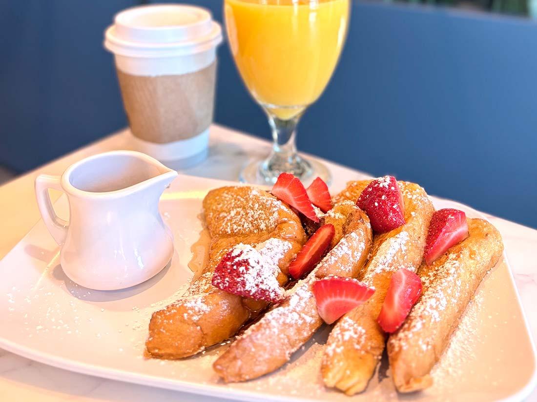 Beachside French toast with strawberries, powdered sugar, coffee & juice at Sundrift Inn.
