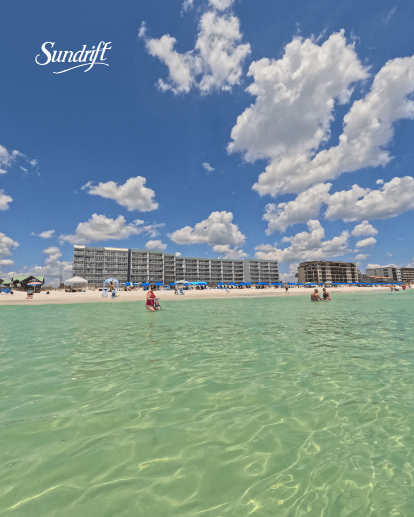People enjoying the clear emerald water at Sundrift Inn on Okaloosa Island in Fort Walton Beach Florida along the Emerald Coast
