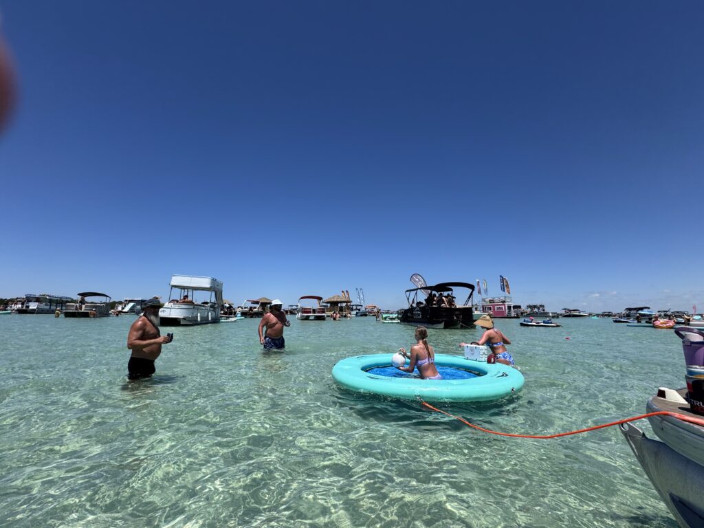 Destin Boat Company charter guests enjoying shallow emerald water at Crab Island near Destin Harbor Florida