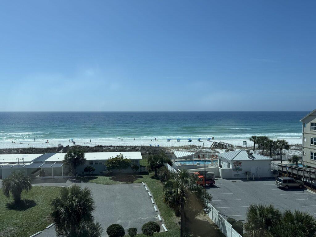 Beachfront hotel view on Okaloosa Island with white sand and emerald water