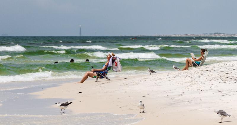 Sunny June beach day on Okaloosa Island with emerald water and white sand