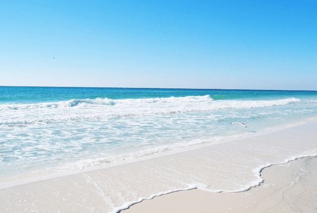 Okaloosa Island beach in Fort Walton Beach Florida with white sand and emerald water along the Emerald Coast