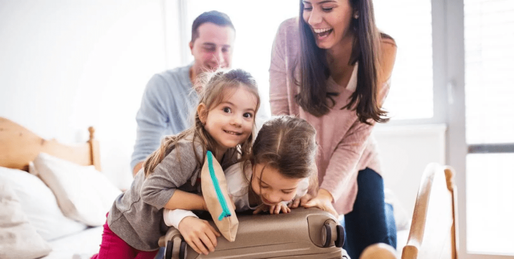 Family packing a suitcase for a beach vacation to Destin Florida