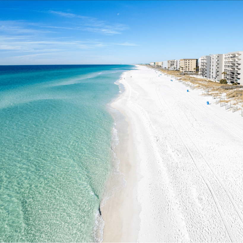 Aerial view of Okaloosa Island beach with white sand and emerald water in Fort Walton Beach Florida on the Emerald Coast