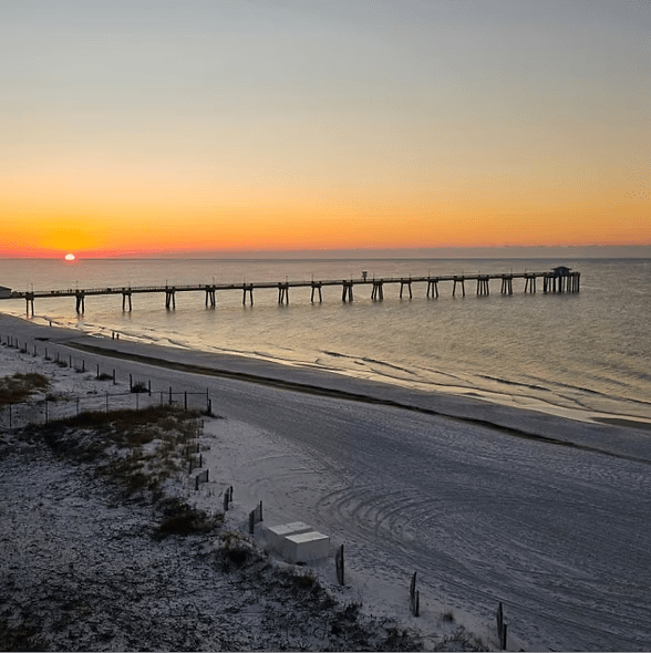 Sunset view of Okaloosa Island Pier extending into the Gulf of America along the Emerald Coast in Fort Walton Beach Florida