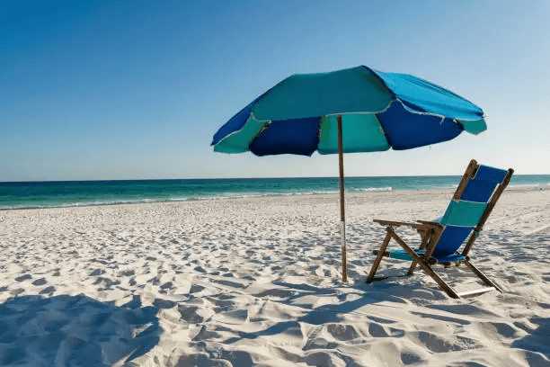 White sand beach in Fort Walton Beach Florida with beach chairs and umbrella along the Emerald Coast shoreline