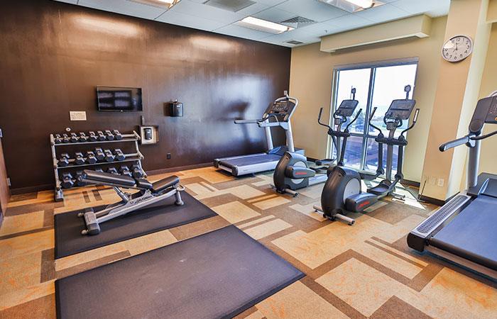 Sundrift Inn fitness center in Fort Walton Beach Florida with cardio equipment and free weights