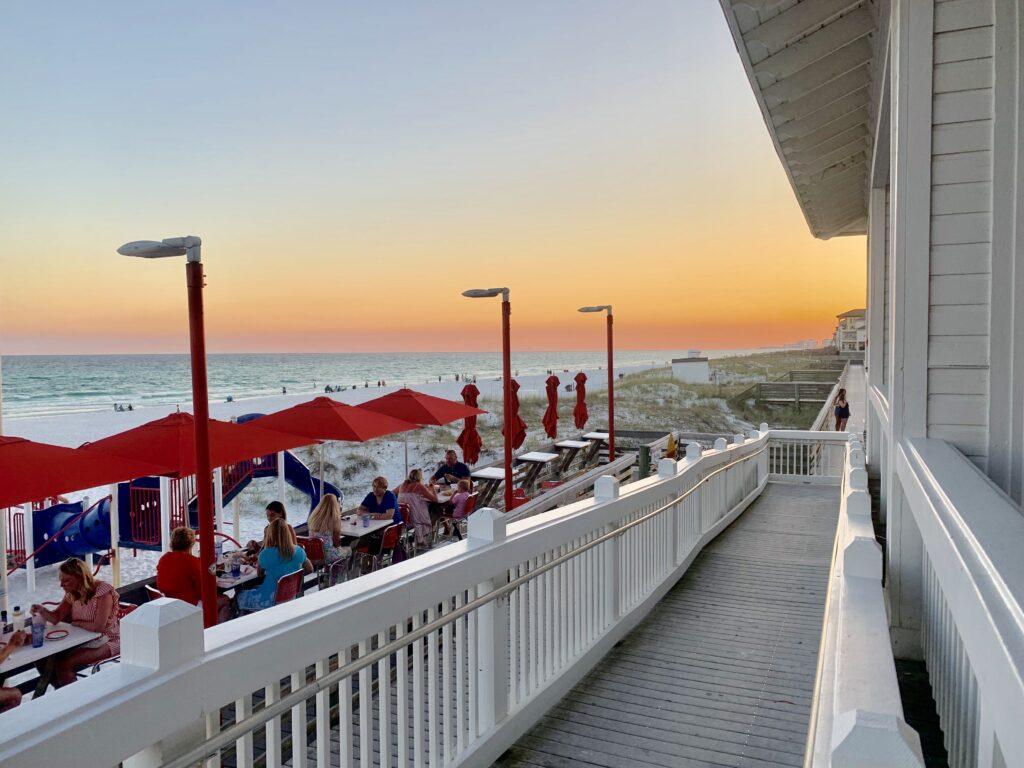 Beachfront dining at The Crab Trap with views of the Gulf of America and white sand beach