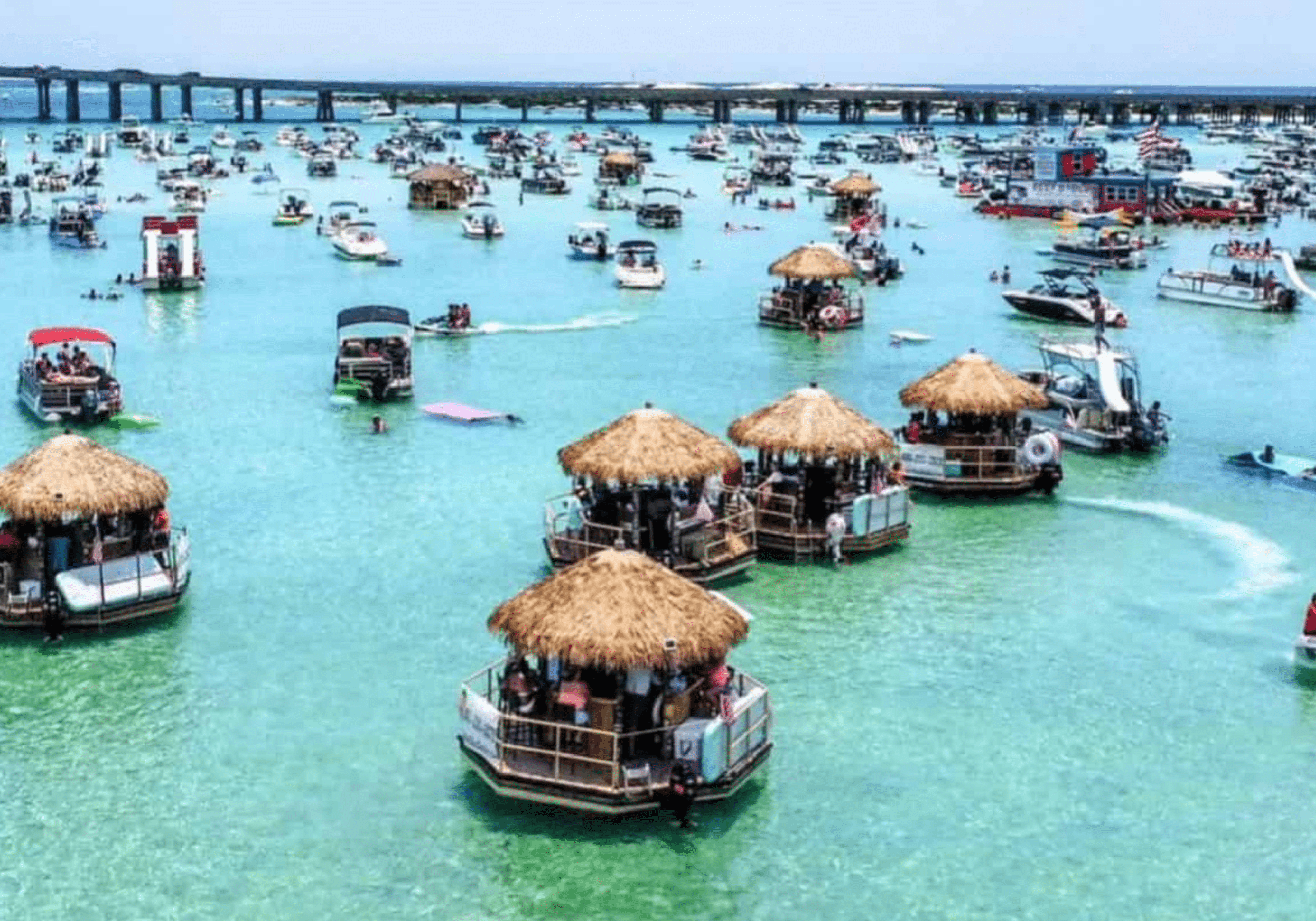 Aerial view of Crab Island with floating tiki huts and boats in Destin Florida