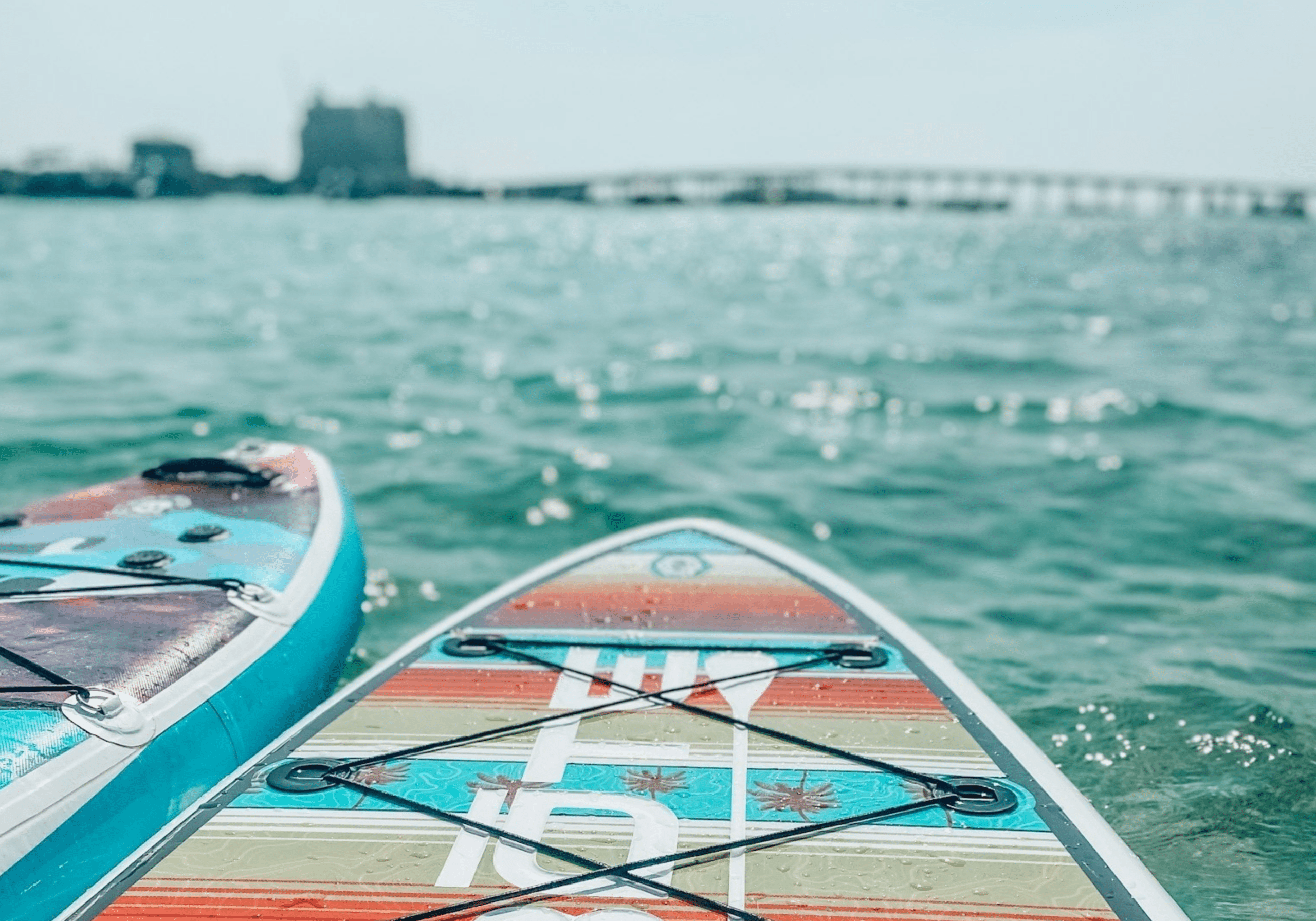 Paddleboards and kayaks on the water near Crab Island in Destin Florida