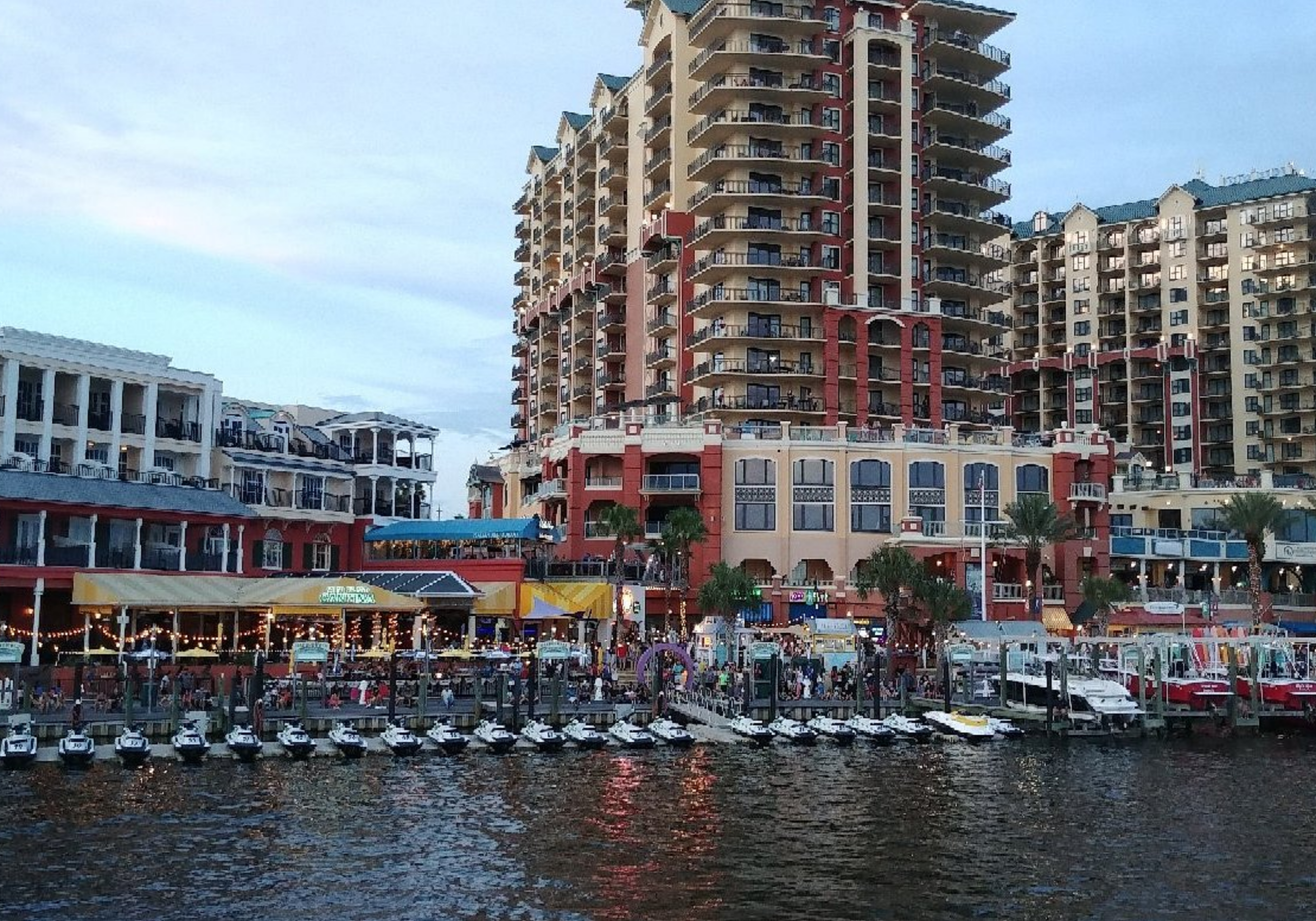 Destin Harbor waterfront with boats, restaurants, and shops in Destin Florida