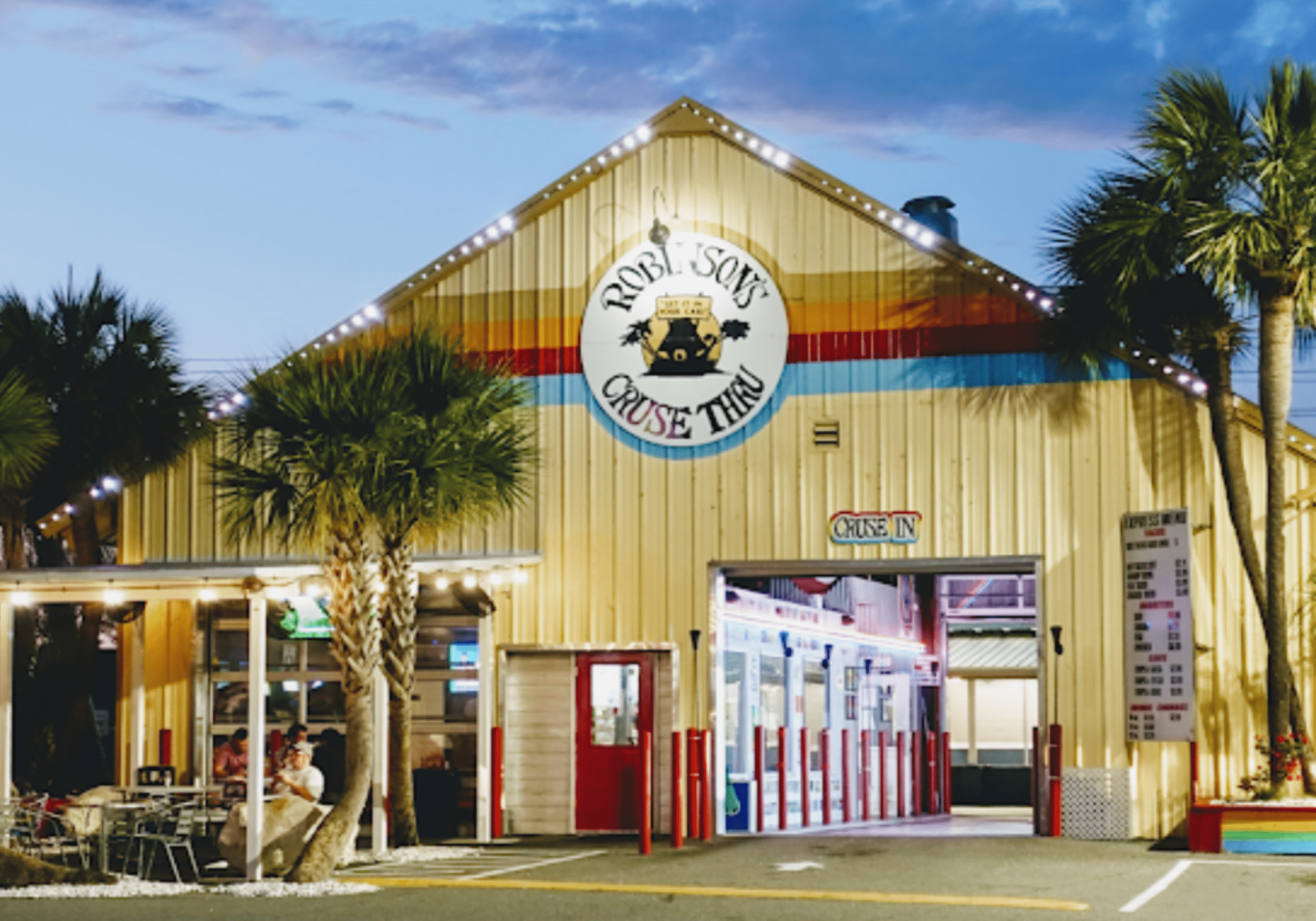 restaurant exterior at night in Destin Florida with outdoor seating and lights