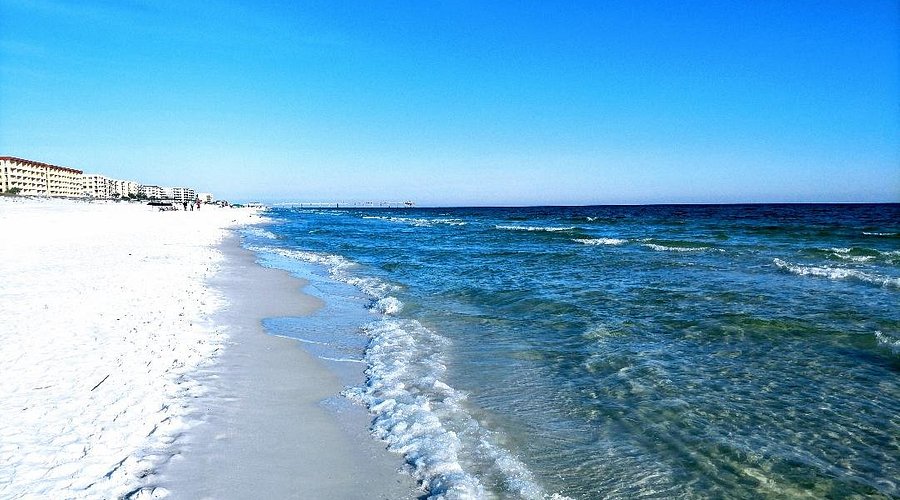 Peaceful beach on Okaloosa Island in Fort Walton Beach Florida with emerald green water