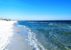 Peaceful beach on Okaloosa Island in Fort Walton Beach Florida with emerald green water