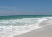 White sand beach on Okaloosa Island in Fort Walton Beach Florida with emerald water and peaceful shoreline