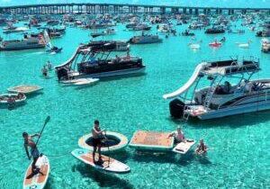 Paddleboarding and boats at Crab Island in Destin Florida