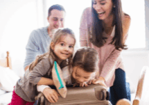 Family packing a suitcase for a beach vacation to Destin Florida