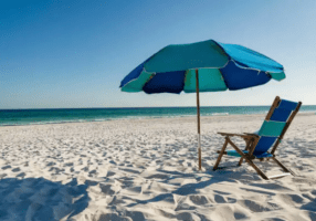 White sand beach in Fort Walton Beach Florida with beach chairs and umbrella along the Emerald Coast shoreline